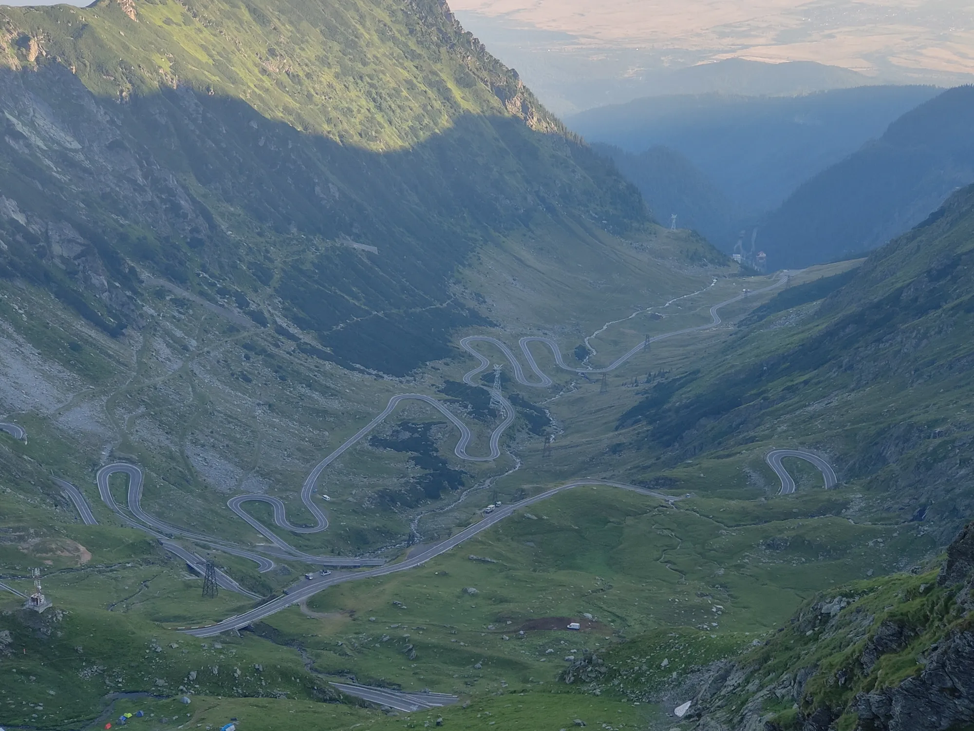 The Transfăgărășan road winding down a green valley