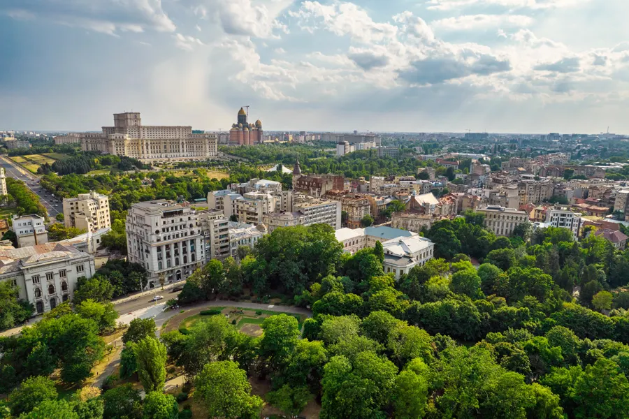 Bucharest seen from above, with the Palace of the Parliament beyond Cișmigiu Gardens