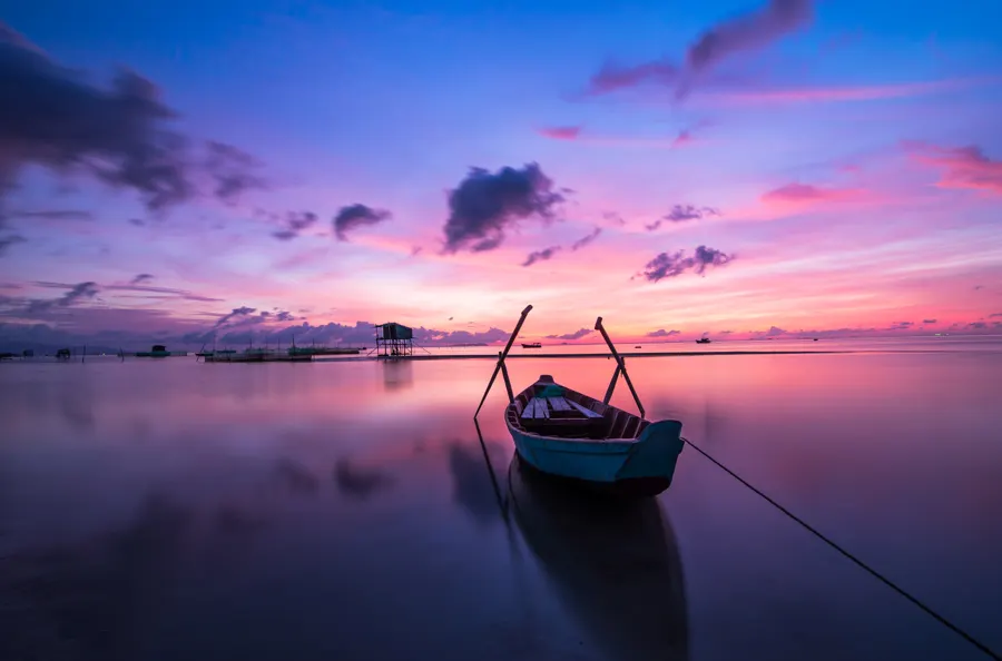 A small boat on calm water in the Danube Delta at dawn