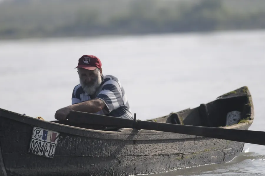 A fisherman rowing his wooden boat in the Danube Delta