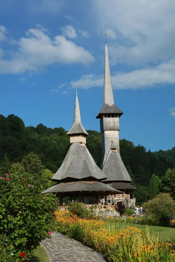 A wooden church with tall twin spires in Maramureș