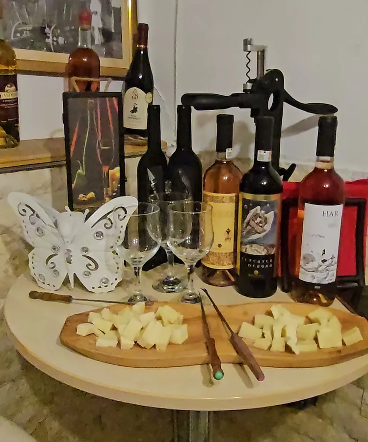 A table with bottles, glasses and local cheese prepared for a wine tasting